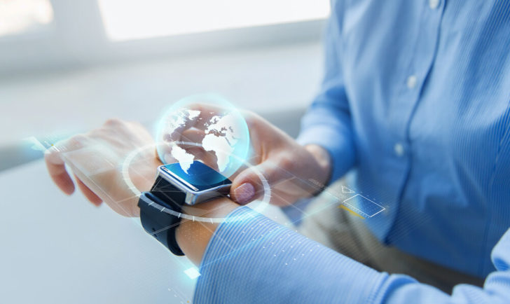 man wearing blue shirt with smart watch and globe Wearable Technologies