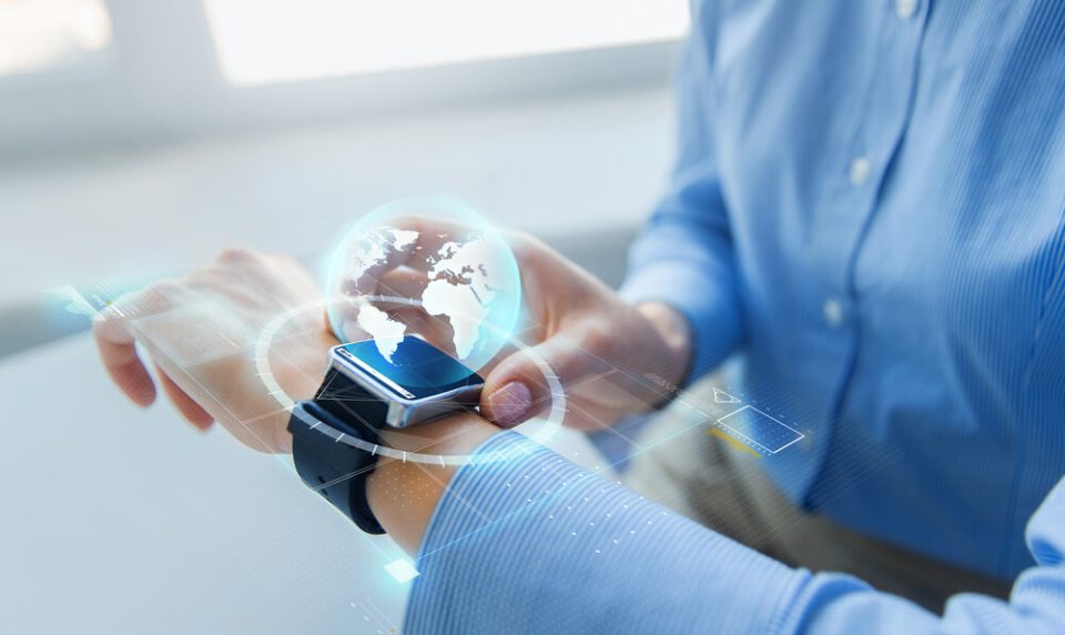 Wearable Technologies man wearing blue shirt with smart watch and globe Wearable Technologies